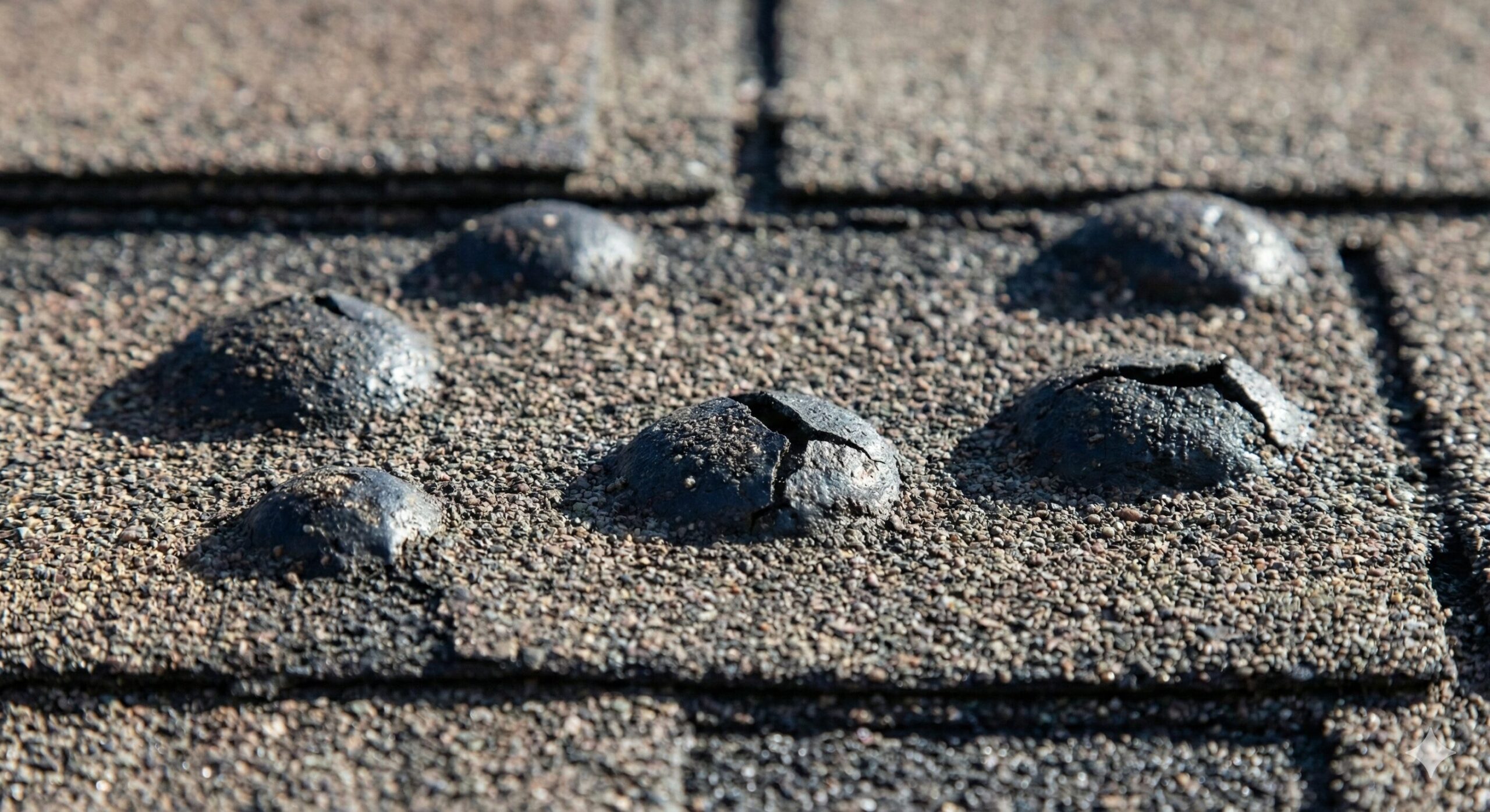 Close up of asphalt shingles with blistering bubbles